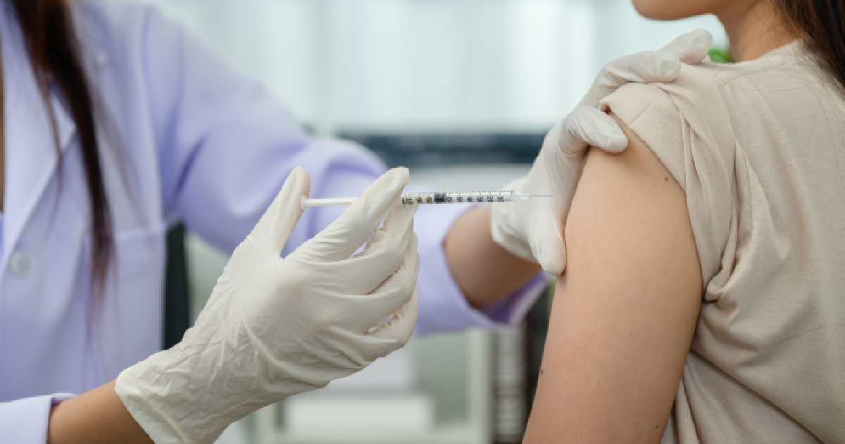 A healthcare professional administering a vitamin shot into a patient’s upper arm, showing the process of Vitamin Injections in Port Orange, FL