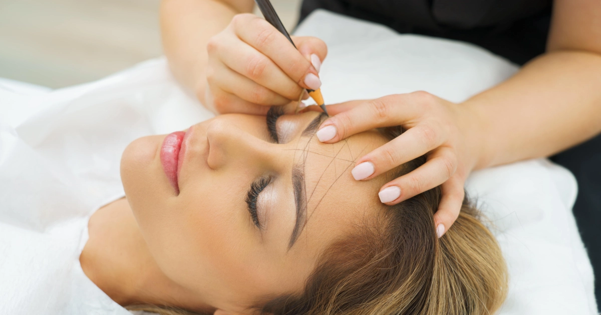 A smiling woman holding a medicine bottle during Microblading in Port Orange, FL