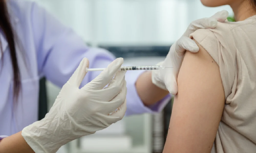 A healthcare professional administering a vitamin shot into a patient’s upper arm, showing the process of Vitamin Injections in Port Orange, FL